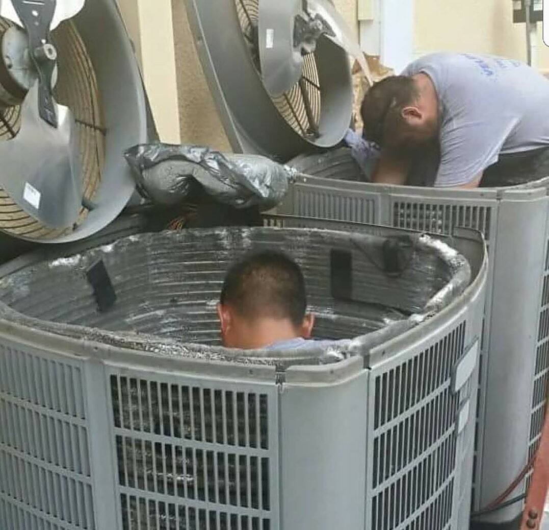 HVAC technicians performing AC repair
